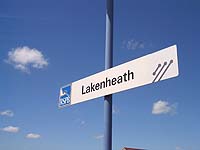RSPB and National Express logos on station name signs at Lakenheath.  Picture: Chris Wood, 2003.